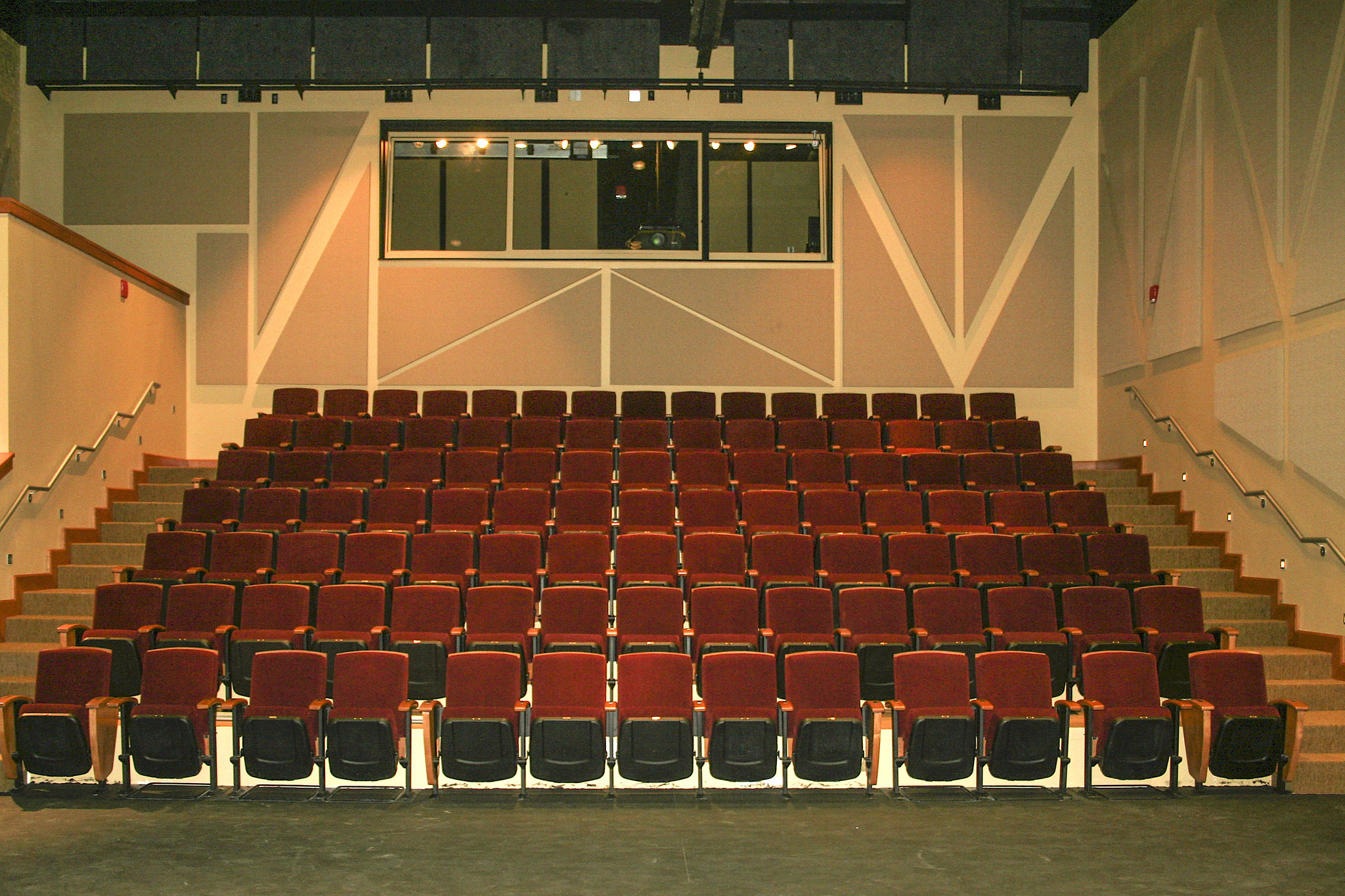 Interior photo of seating in the Kennedy-McIlwee Studio Theatre at NC State University. Seven rows of theatre seats inside a raked house. Fifteen seats each on rows B though G. Thirteen seats on row A (no steps), with eight that are removable for flexible accessible seating.