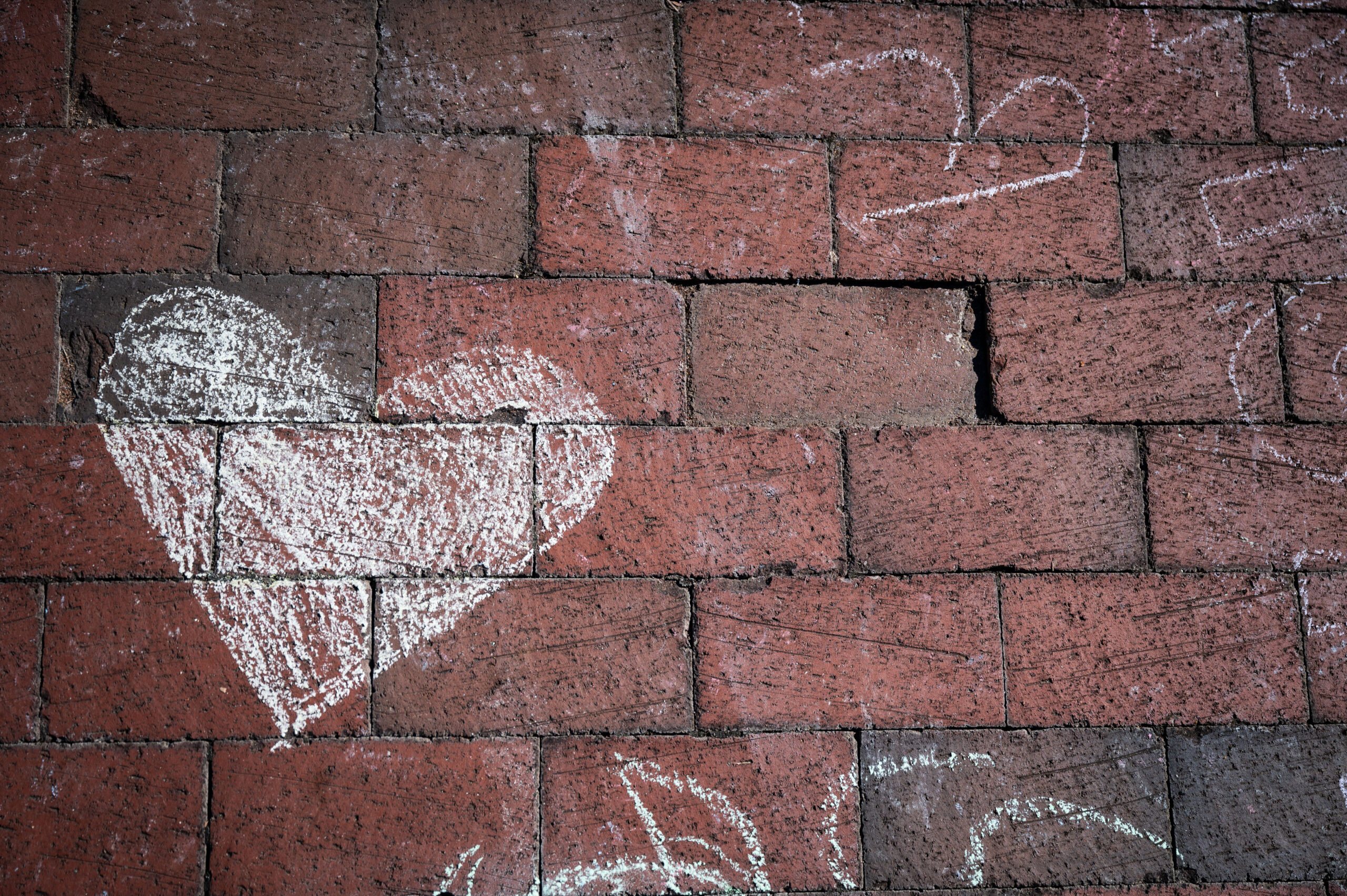 A heart is chalked onto bricks at Wolf Plaza during a wellness event. Photo by Marc Hall